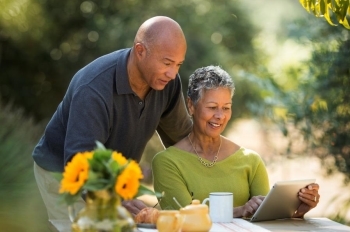 Couple reviewing information on tablet